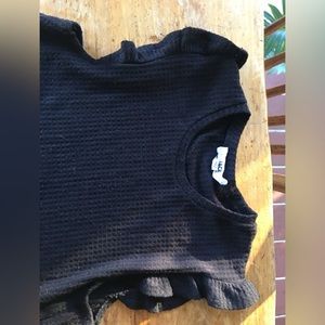 Black, light work wear vest with ruffle sleeves.